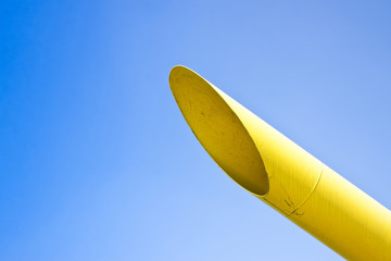 Detail of a varnished metal tube on blue background