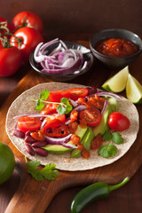 vegan taco with avocado tomato kidney beans and salsa