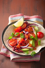 vegan taco with avocado tomato kidney beans and salsa