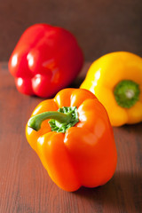 healthy colorful bell peppers on rustic background