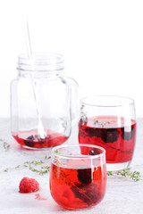 glass of berry drink with fresh fruits on marble table