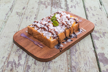 Toast cream is placed on a wooden table
