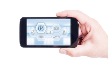 Contact us options concept with hand holding smartphone