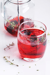 glass of berry drink with fresh fruits on marble table.