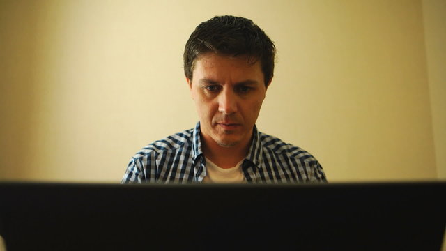 Man is carefully working on a notebook
