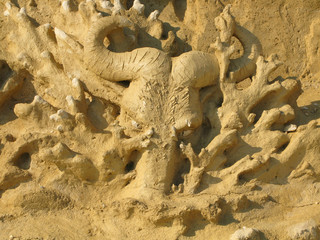 Art handmade composition of sandy material in sunlight