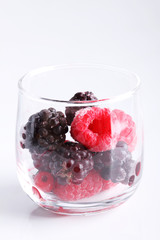 raspberry and blackberry, frozen berries on marble background