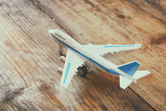 toy airplane over wooden textured table. retro style image
