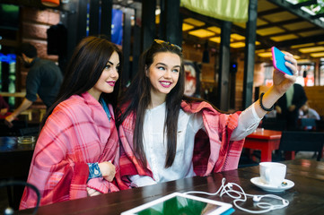 two close friends make selfie in the cafe