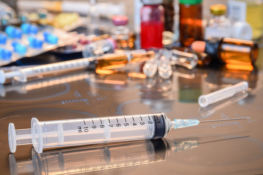  Glass Medicine Vials ampule ,medicine pill and capsule Syringe on x-ray film over doctor table for background (shallow DOF)
