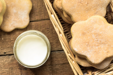 Glass of milk and cookies in a basket