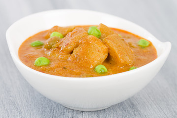 Aloo Matar - Potatoes and green peas cooked in a mild creamy tomato gravy.

