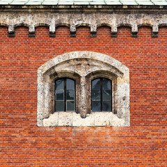 Weathered brick facade with double stone window