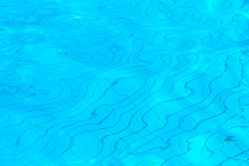 Fototapeta na wymiar Blue ripple water in swimming pool