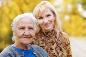 Elderly women with daughter in a garden