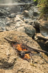Natural Fire on Rocks Along Riverbed