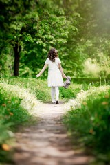 Girl walks in summer park