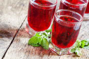 Pomegranate red cocktail with mint, selective focus