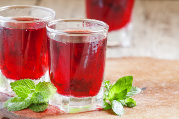Pomegranate red cocktail with mint, selective focus