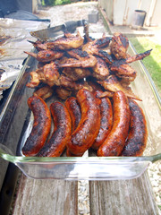 chicken and sausage cooked on a grill