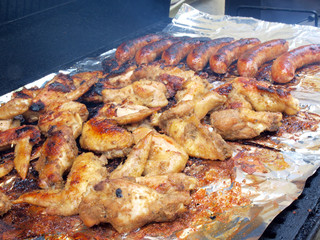 chicken and sausage on the grill