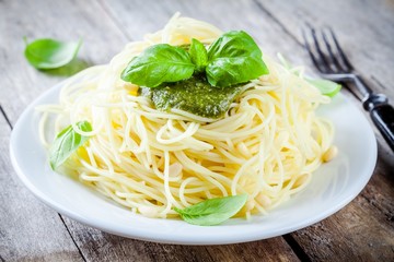 Spaghetti with pesto sauce and basil