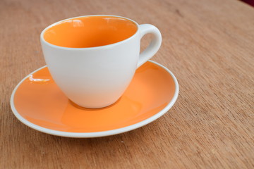 Empty coffee or tea cup on wood board, selective focus