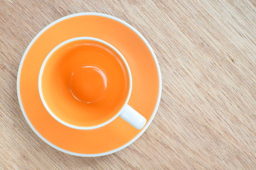 Empty coffee or tea cup on wood board, selective focus
