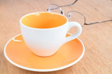 Empty coffee or tea cup on wood board, selective focus