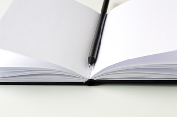 Black Pencil on an Open Notebook 