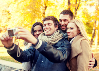 Fototapeta premium group of smiling men and women making selfie