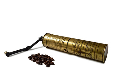 Vintage grinder and coffee beans isolated on white background