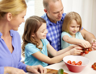 happy family with two kids cooking at home