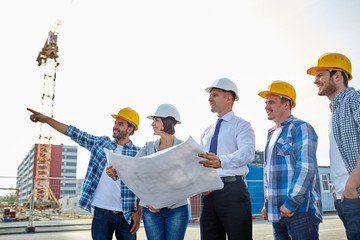 group of builders and architects with blueprint