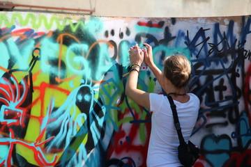 young woman girl spraying grafity