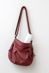 Red bag hanging  over a white wall