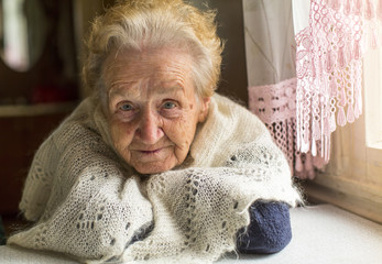Portrait of an elderly woman near the window.