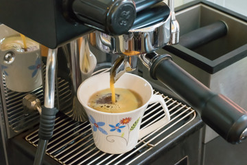 Fresh espresso on the coffee machine