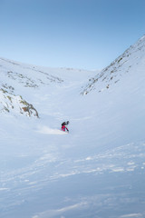 people tourists descend on a skateboard on snow-covered mountain