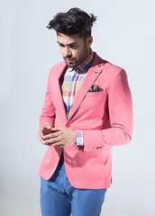 sexy fashion male model dressed elegant - casual posing against wall