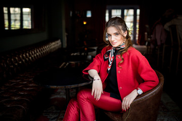 beautiful young and stylish Successful business woman in a red suit looking confident and smiling