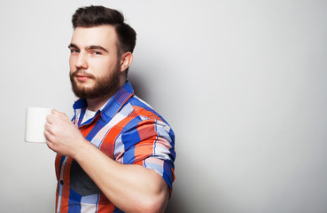 young bearded man with a cup of coffee