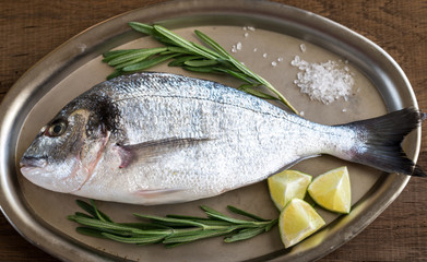 Fresh dorada with ingredients on the vintage tray