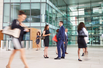 People passing through the busy foyer of a business building