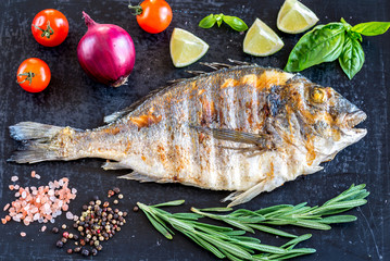 Grilled dorada fish fresh vegetables and herbs