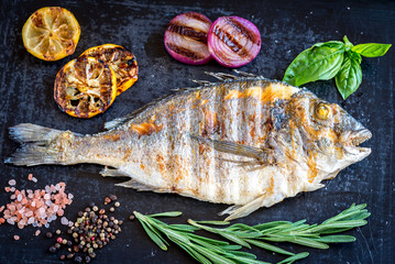 Grilled dorada fish fresh vegetables and herbs