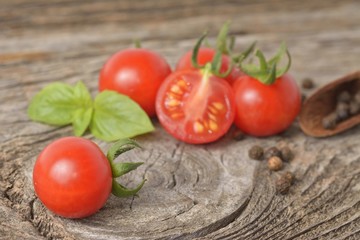 Tomatoes with basil on wooden table