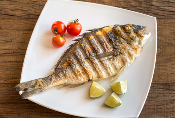 Grilled dorada with lemon and cherry tomatoes