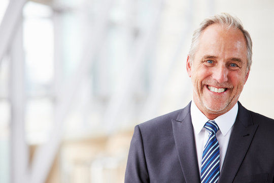 Head and shoulders portrait of smiling senior businessman