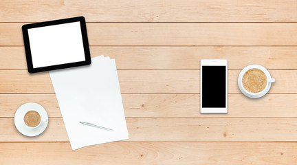 Two gadgets and coffee on a wooden table